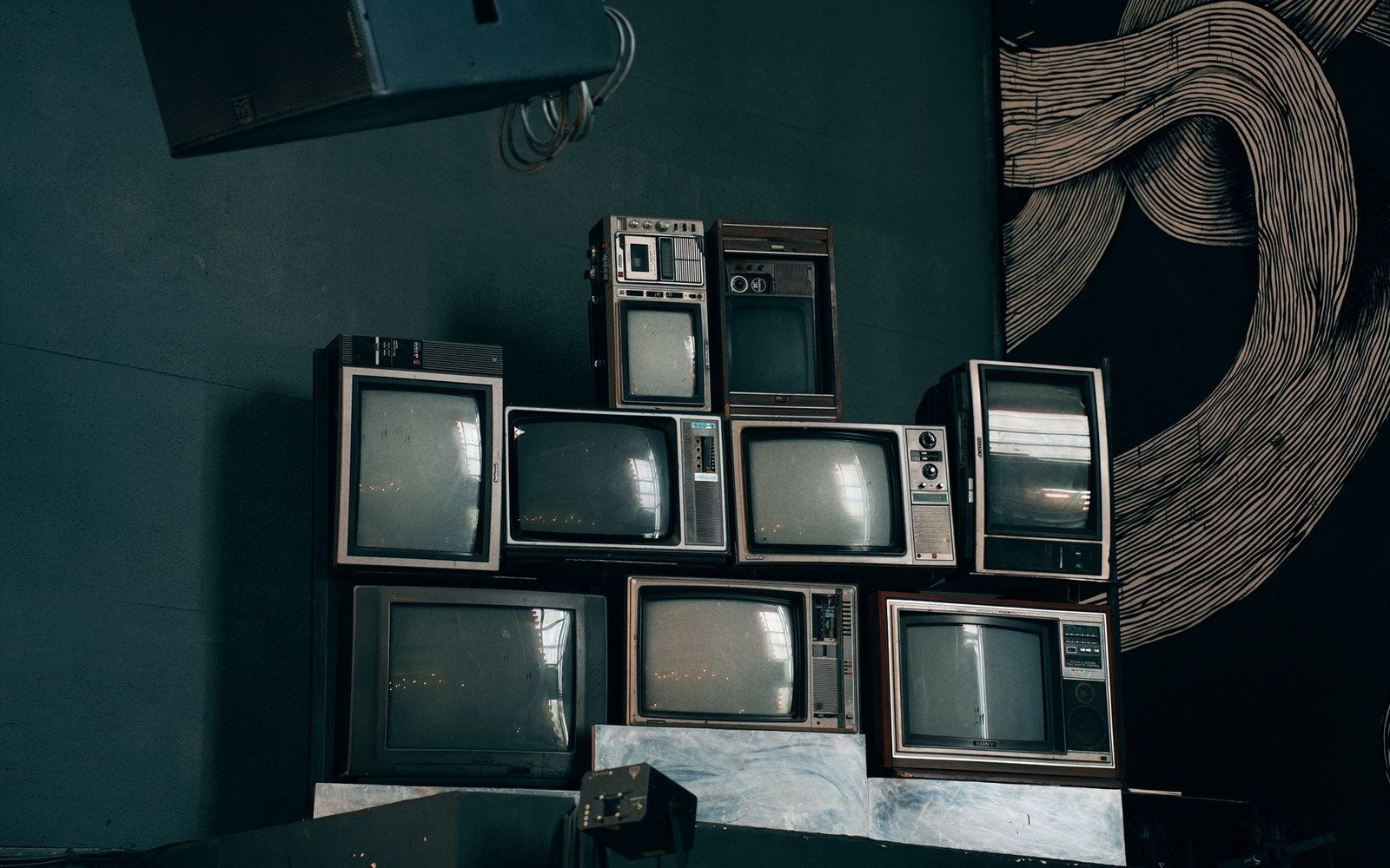 A CRT glowing in an otherwise dark room, close