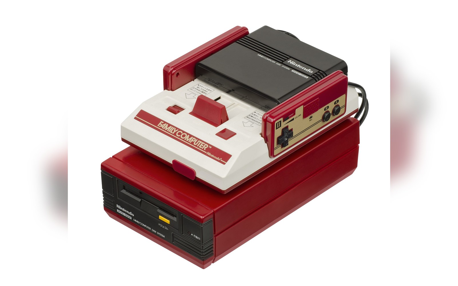 Nintendo Famicom console stacked on its disk system attachment with cartridge inserted