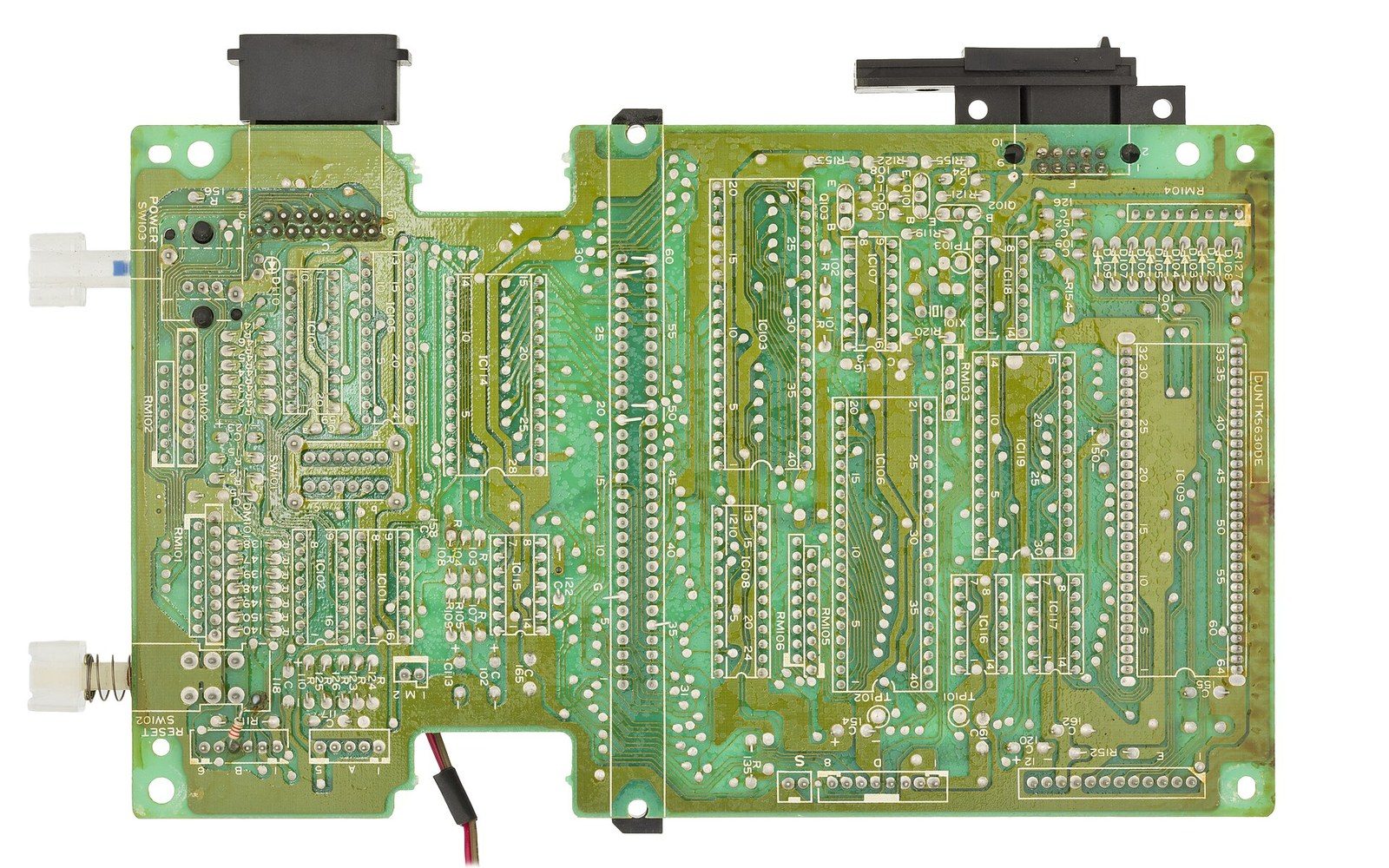 A socketed chip on a green board, macro, one hard light